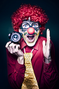 Excited Clown With Camera At Kids Birthday Party