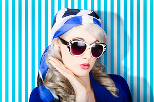 Beautiful retro pinup girl in scarf and sunglasses
