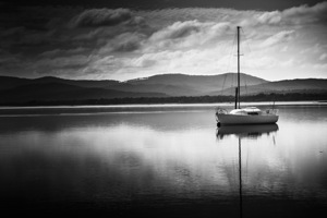 Yacht sailing boat with sails down in Port Sorell 