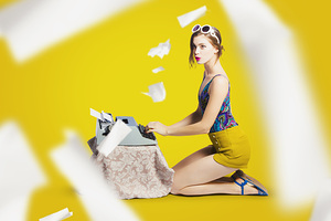 Pinup typist writing story on typewriter