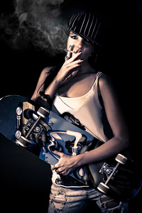 Skater girl smoking a cigarette