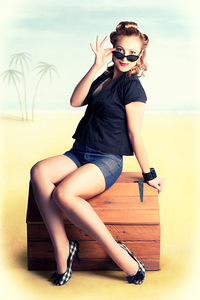 Travelling Pin-Up Girl Sitting On Vintage Luggage