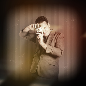 Retro photographer man taking photo with camera