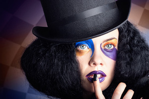 Eccentric mad fashion hatter in colourful makeup