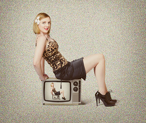 Female television show actress on old TV set