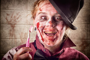 Zombie at dentist holding toothbrush. Tooth decay