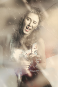 Pin-up woman dancing in a shower of rain