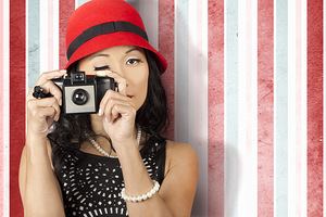 Pin-up photographer in 40s fashion holding camera