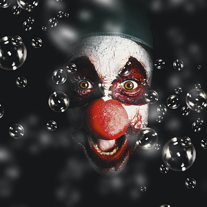 Scary horror circus clown laughing with evil smile