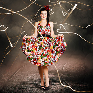 Woman dancing in colorful floral dress outdoor