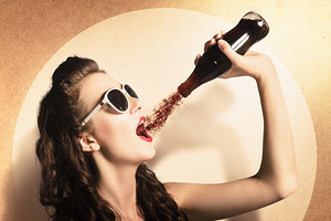 Young pinup woman in sunglasses drinking soda