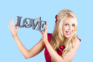 Fun blonde woman with love word sign