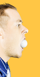 Man with golf ball in mouth