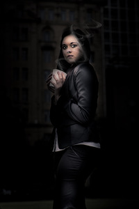 Mysterious Woman Standing In Darkness With Coffee