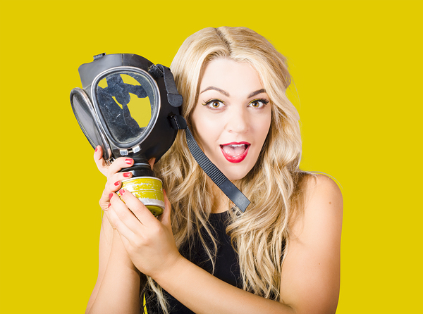 Woman in fear holding gas mask on white background Print