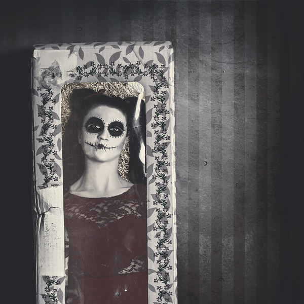 Possessed sugar skull doll inside vintage toy box Print