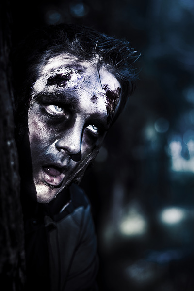 Head of a scary zombie peeking from behind tree Print