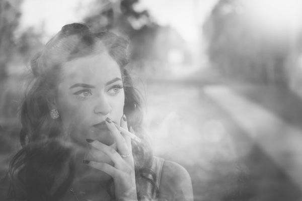 Film noir lady smoking cigarette on vintage street Print