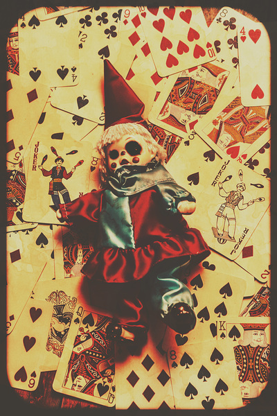 Evil clown doll on playing cards Print