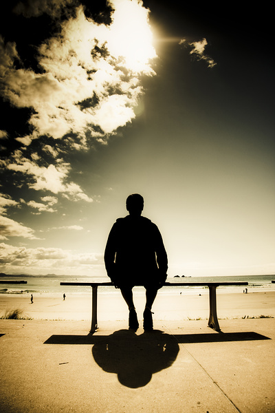 Young Man In Silhouette Sitting In The Sun Print