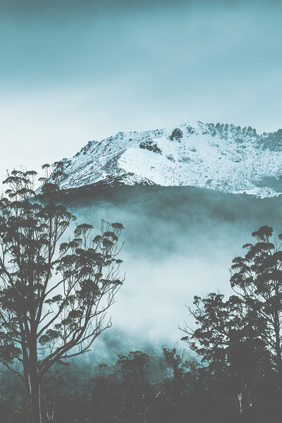 Dramatic dark blue mountain with snow and fog Print