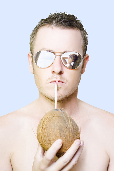 Handsome summer man drinking coconut cocktail Print
