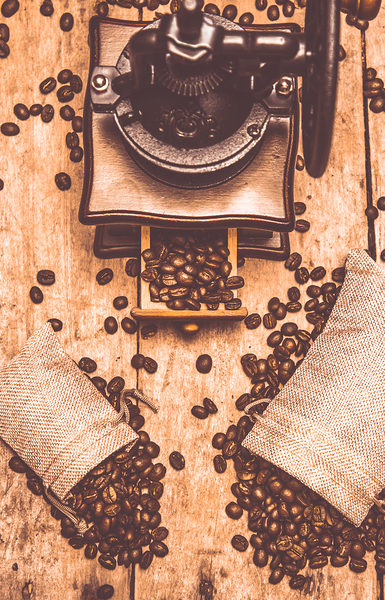 Vintage grinder with sacks of coffee beans Print