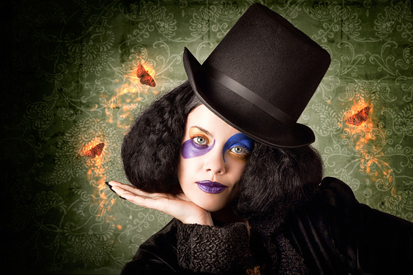 Stylish female magician performing magic trick Print