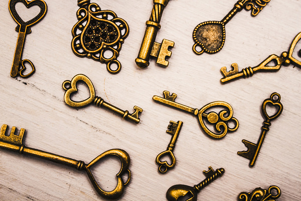 Metal keys of different size on wooden table Print