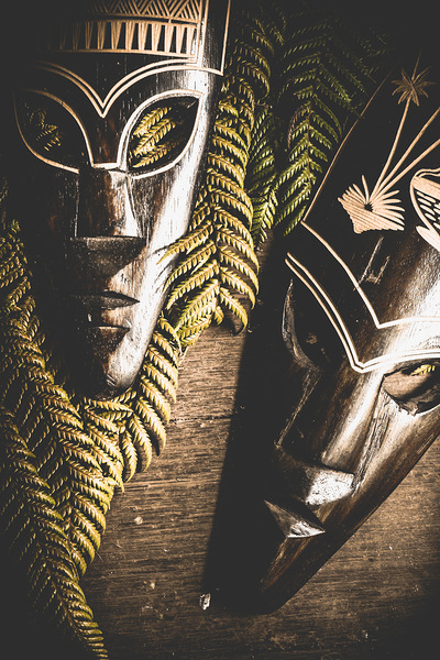 Tribal Masks With Ferns On Wooden Table Print