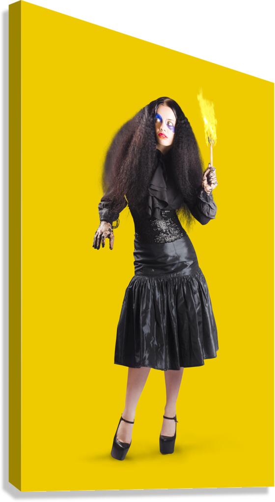 Female jester holding lit fire torch Canvas Print