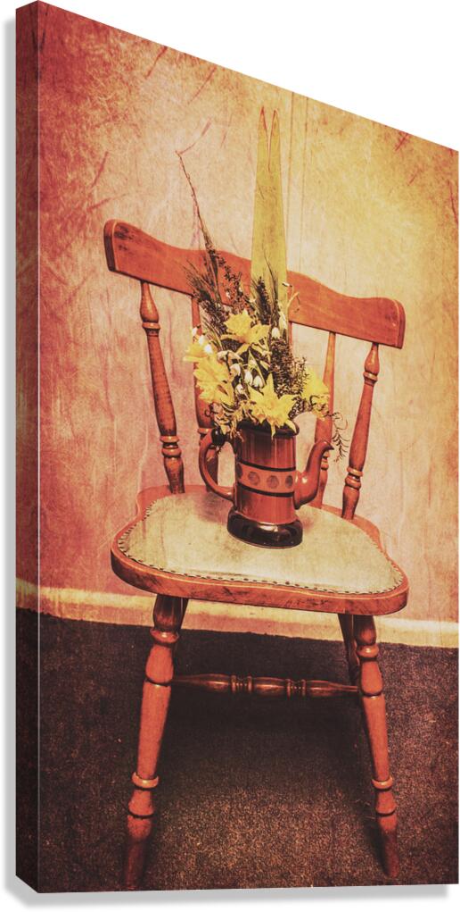 Decorated flower bunch on old wooden chair Canvas Print