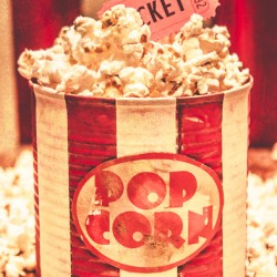 Retro tub of butter popcorn and ticket stub