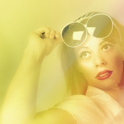 Beautiful retro pin-up girl wearing futuristic sunglasses 