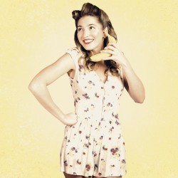 Funny pin-up model in conversation on banana phone