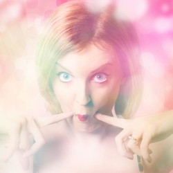 Blushing pinup girl in haze of makeup hues