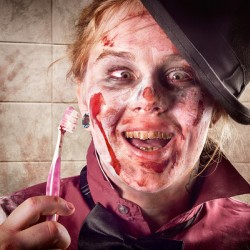 Zombie at dentist holding toothbrush. Tooth decay