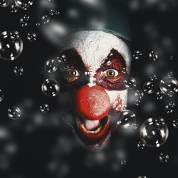 Scary horror circus clown laughing with evil smile