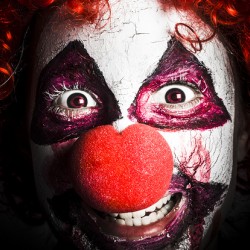 scary and evil clown smiling in dark spooky style