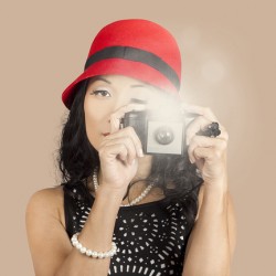 Cute pin up Asian lady taking photo with camera