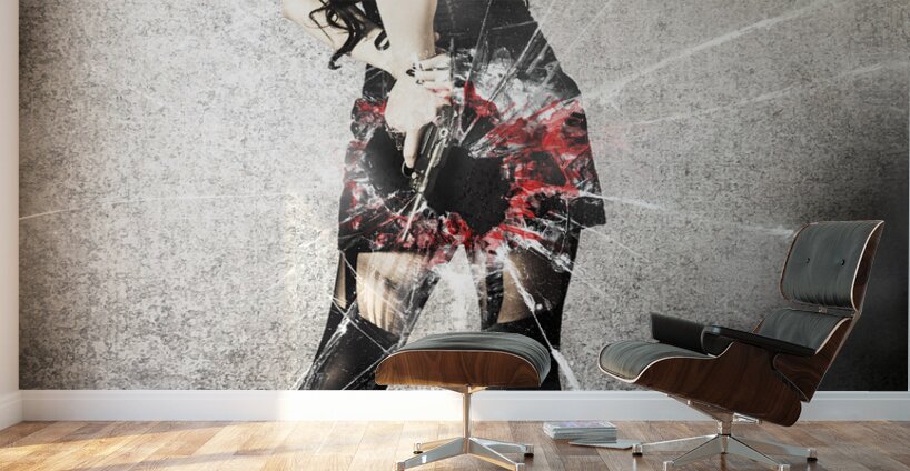 Sexy brunette woman holding gun with deadly style Wall Murals