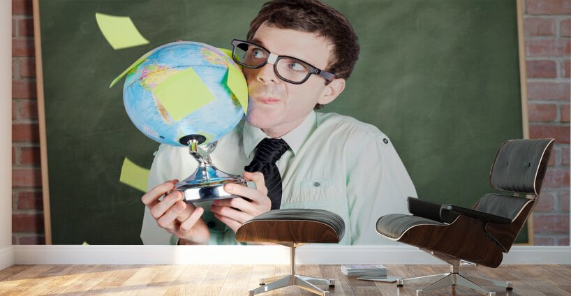 Nerd man holding earth world globe in classroom Wall Murals