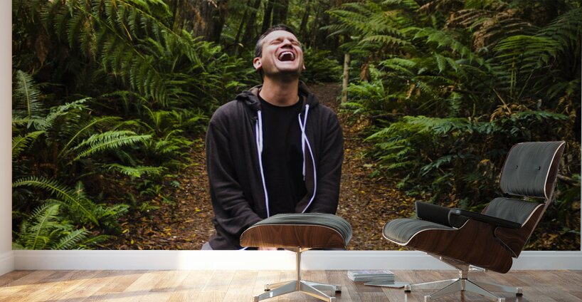 Travel man laughing in Tasmania rainforest Wall Murals