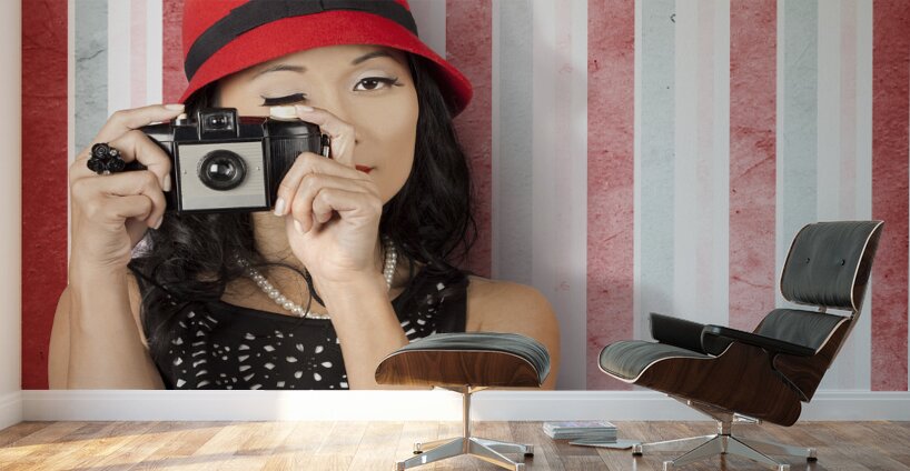 Pin-up photographer in 40s fashion holding camera Wall Murals