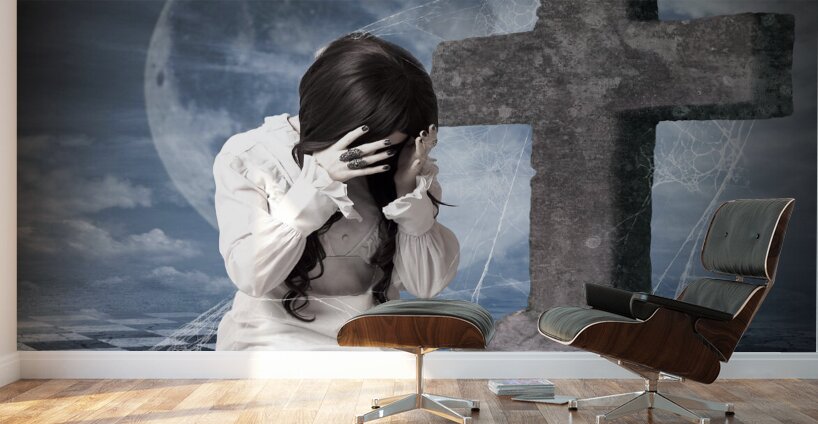 Grieving gothic girl crying next to gravestone Wall Murals