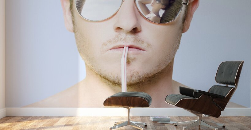 Handsome summer man drinking coconut cocktail Wall Murals