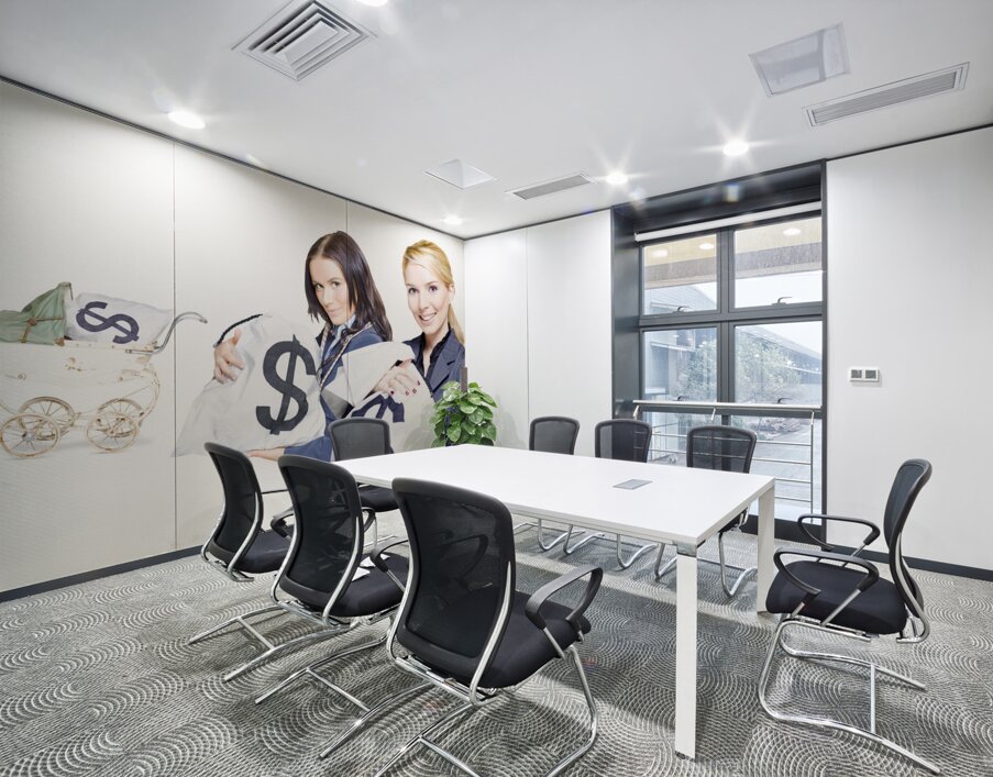 Pretty young business women holding sacks of money Wall Printing
