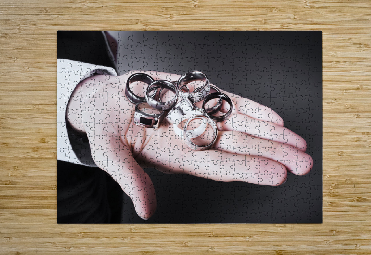 Man displaying a selection of stylish rings Jorgo Puzzle printing